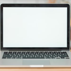 modern-laptop-with-blank-white-screen-wooden-table